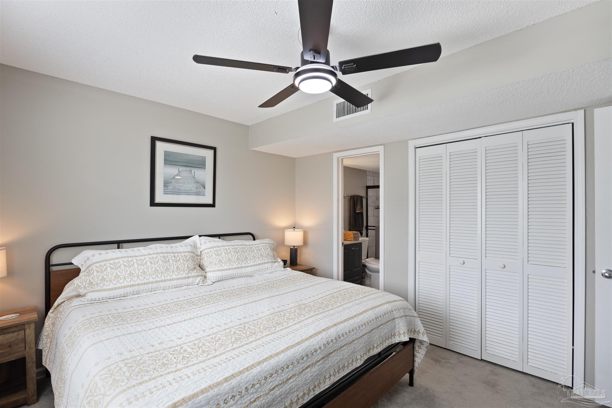 14100 River Road, Unit 122B Perdido Key, FL 32507 - Photo 23 of 46 a bedroom with a bed and a chandelier