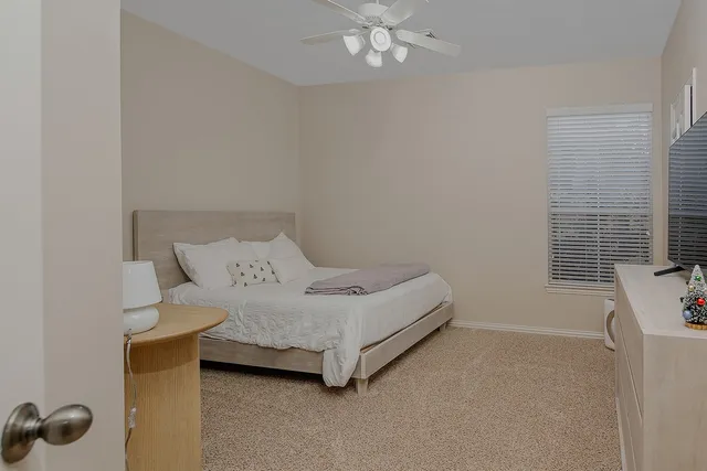 a bedroom with a bed and a window