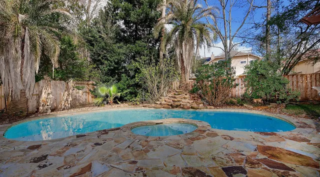 a view of a backyard with swimming pool