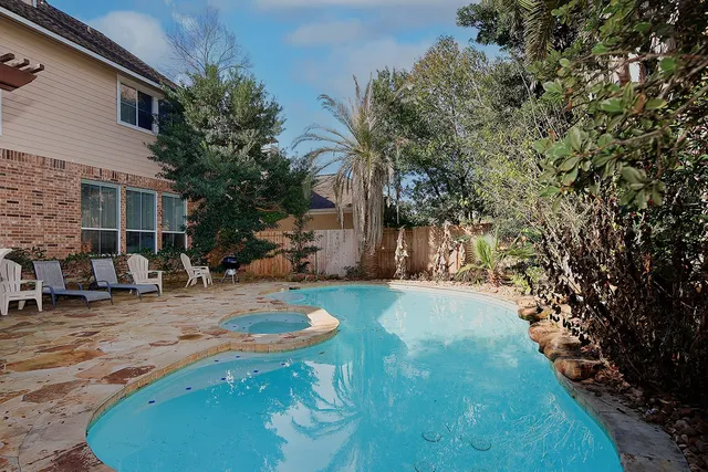 a backyard of a house with table and chairs