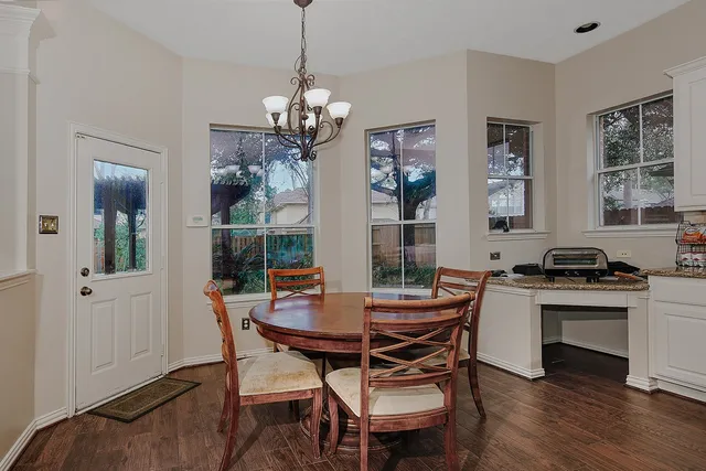 a view of a dining room with furniture window and wooden floor