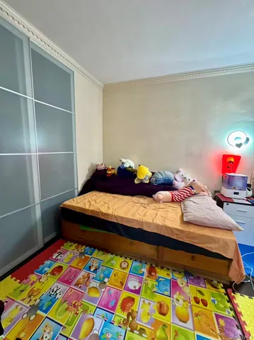 a bedroom with a bed and a dresser in it