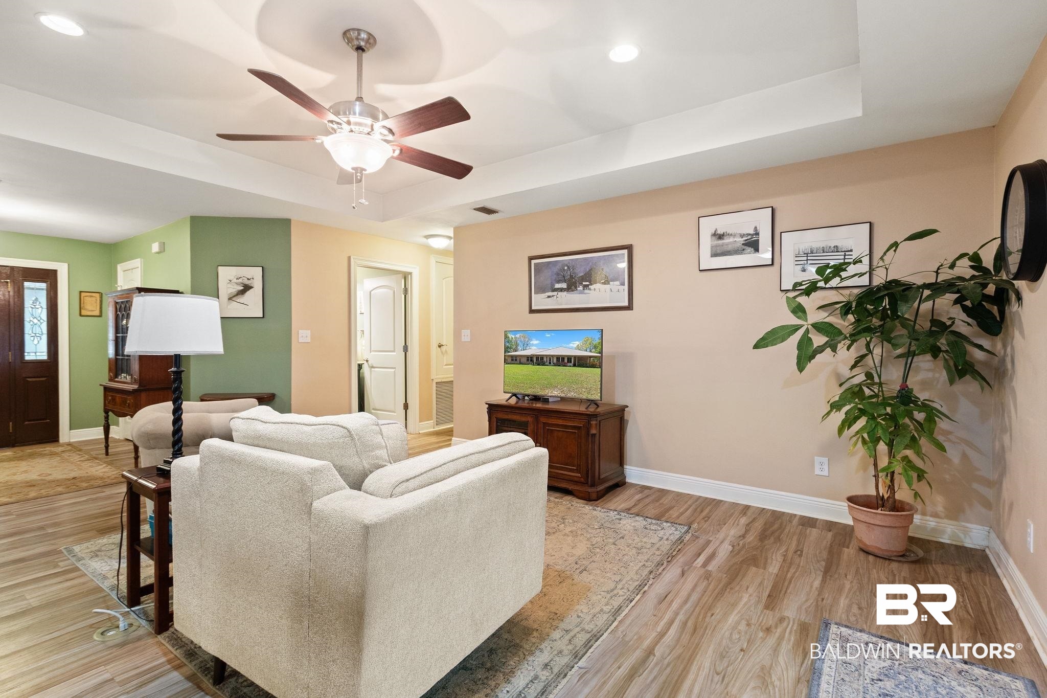 24250 Hack Road Bay Minette, AL 36507 - Photo 10 of 88 Living area with ceiling fan, a raised ceiling, light wood-style floors, and recessed lighting