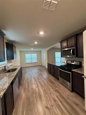 a view of a house with a big yard and large trees