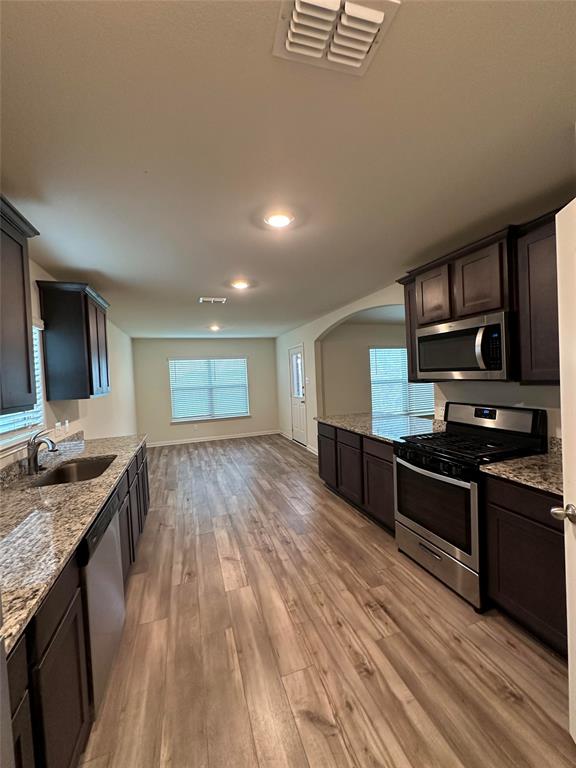 3122 Zapta Road Forney, TX 75126 - Photo 3 of 8 a kitchen with stainless steel appliances granite countertop a stove and a sink