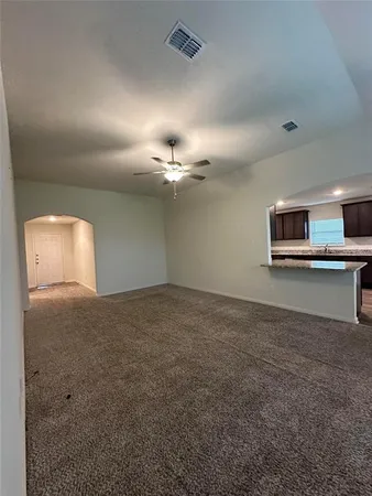 a kitchen with granite countertop stainless steel appliances a sink cabinets and wooden floor