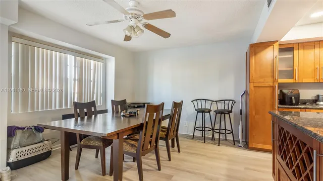 a view of a dining room with furniture and a chandelier