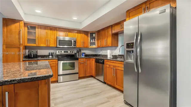 a kitchen with stainless steel appliances granite countertop a stove and a refrigerator