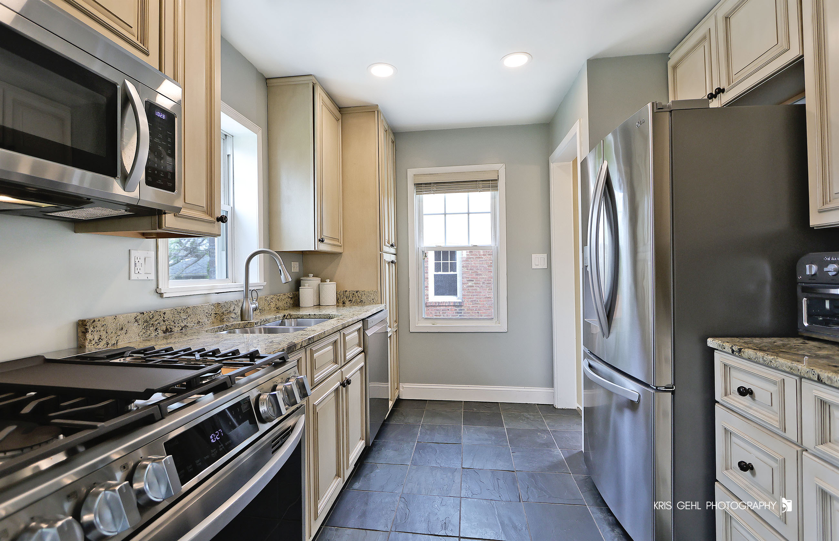 956 Spring Road Elmhurst, IL 60126 - Photo 5 of 26 a kitchen with stainless steel appliances granite countertop a stove a refrigerator and a sink