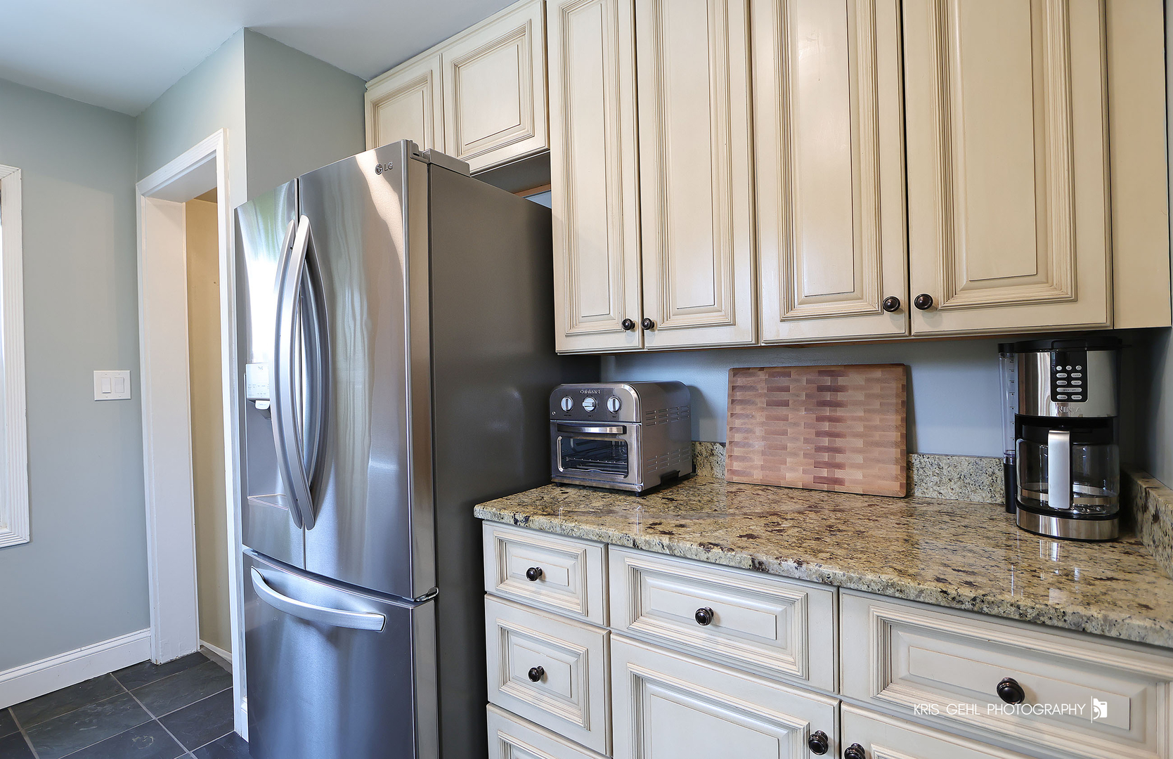 956 Spring Road Elmhurst, IL 60126 - Photo 6 of 26 a kitchen with granite countertop a refrigerator and cabinets