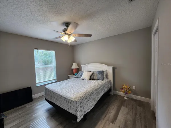 a bedroom with a bed and a chandelier