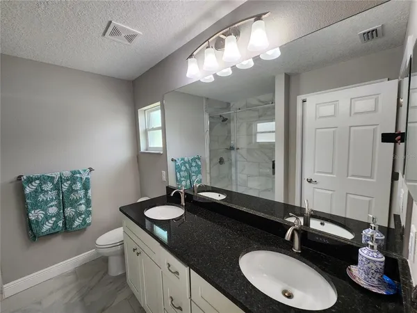 a bathroom with a double vanity sink and a mirror