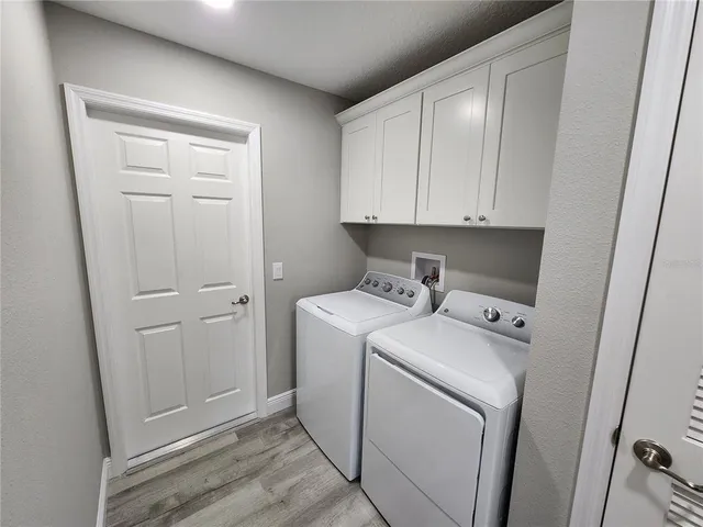 a view of storage and utility room with washer and dryer