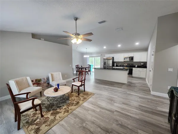a view of a dining room with furniture and a chandelier