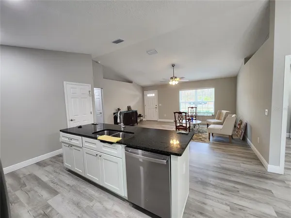 a kitchen with sink and cabinets