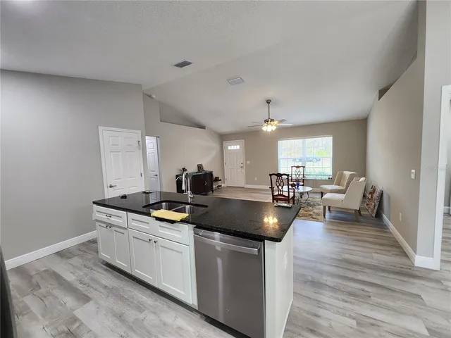 a kitchen with sink and cabinets