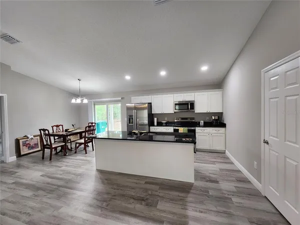 a kitchen with lots of counter top space and appliances