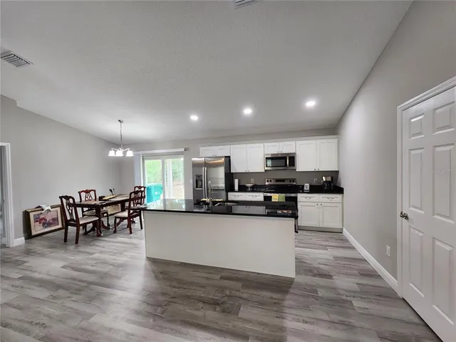 a kitchen with lots of counter top space and appliances