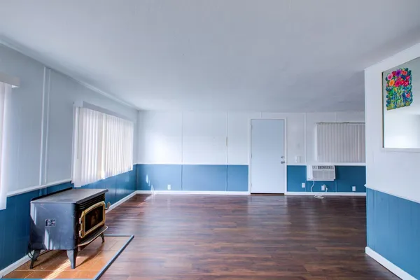a view of kitchen and hall with wooden floor