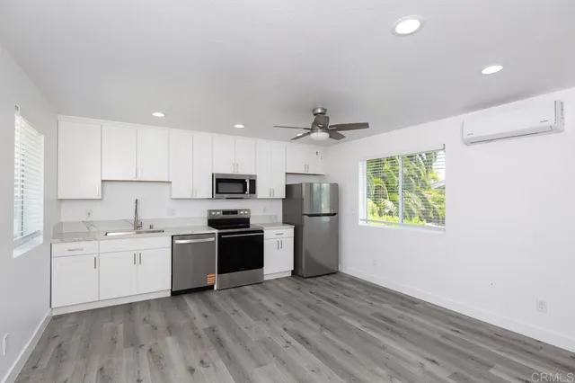 a kitchen with a sink a refrigerator and window