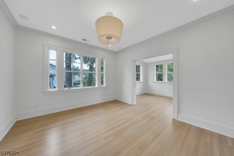 82 Watchung Avenue Montclair, NJ 07043 - Photo 24 of 48 wooden floor in an empty room with a window