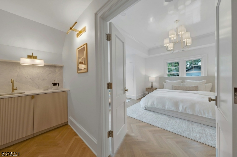 82 Watchung Avenue Montclair, NJ 07043 - Photo 32 of 48 a bedroom with a bed and a chandelier