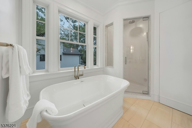 82 Watchung Avenue Montclair, NJ 07043 - Photo 39 of 48 a white bath tub sitting in a bathroom next to a window