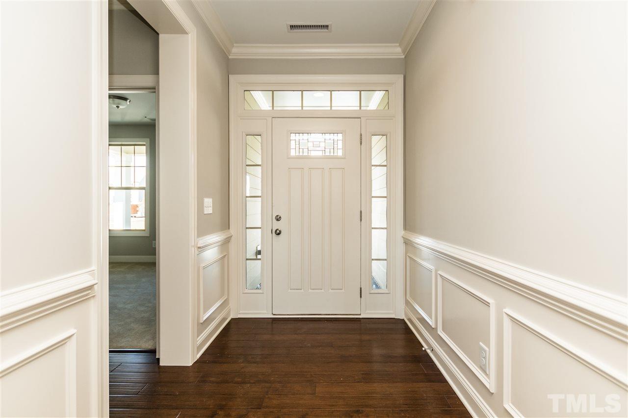 1505 Chestnut Falls Road Wendell, NC 27591 - Photo 3 of 25 Spacious Foyer with 5" hardwood floors, wainscoting and decorative door with side and transom windows