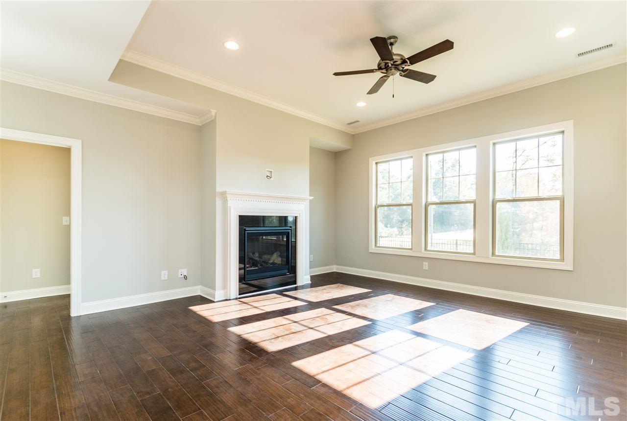1505 Chestnut Falls Road Wendell, NC 27591 - Photo 4 of 25 Bright and open with 10ft. ceilings 5 1/4" crown molding, recessed lighting and ceiling fan, hardwood floors and a raised 40" direct vent fireplace with granite surround