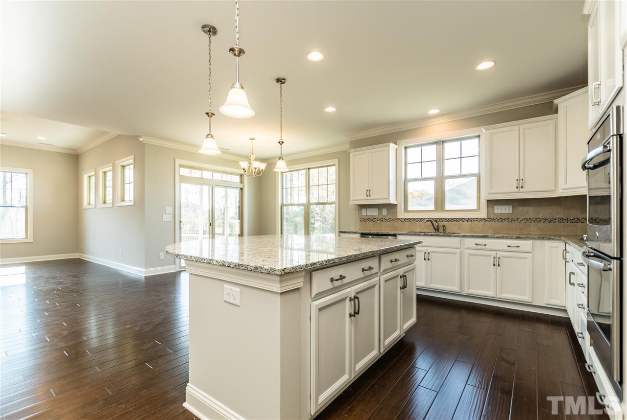 1505 Chestnut Falls Road Wendell, NC 27591 - Photo 9 of 25 White cabinets brighten the room while the hand scrapped 5" hardwood floors provide a nice contrast. GE Stainless Steel Double Oven with convection is great for the holidays and special occasions, Great lighting with both recessed and pendant lighting.