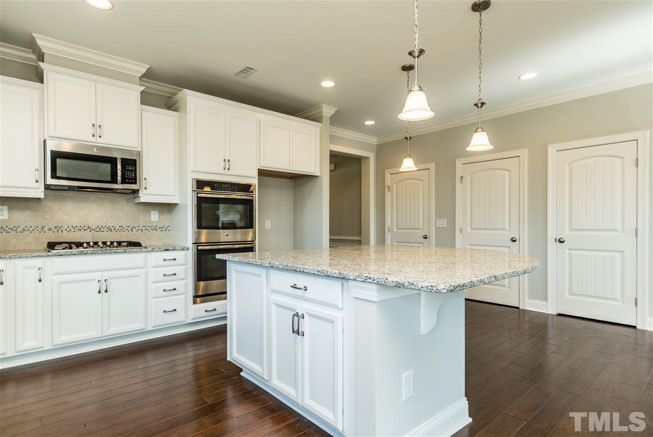1505 Chestnut Falls Road Wendell, NC 27591 - Photo 10 of 25 Plenty of cabinet and countertop space great for storage and food preparation. The Oversized Kitchen Island provides additional seating and the GE Café Cooktop provides a cast iron griddle. Built-in microwave is vented to the outside.