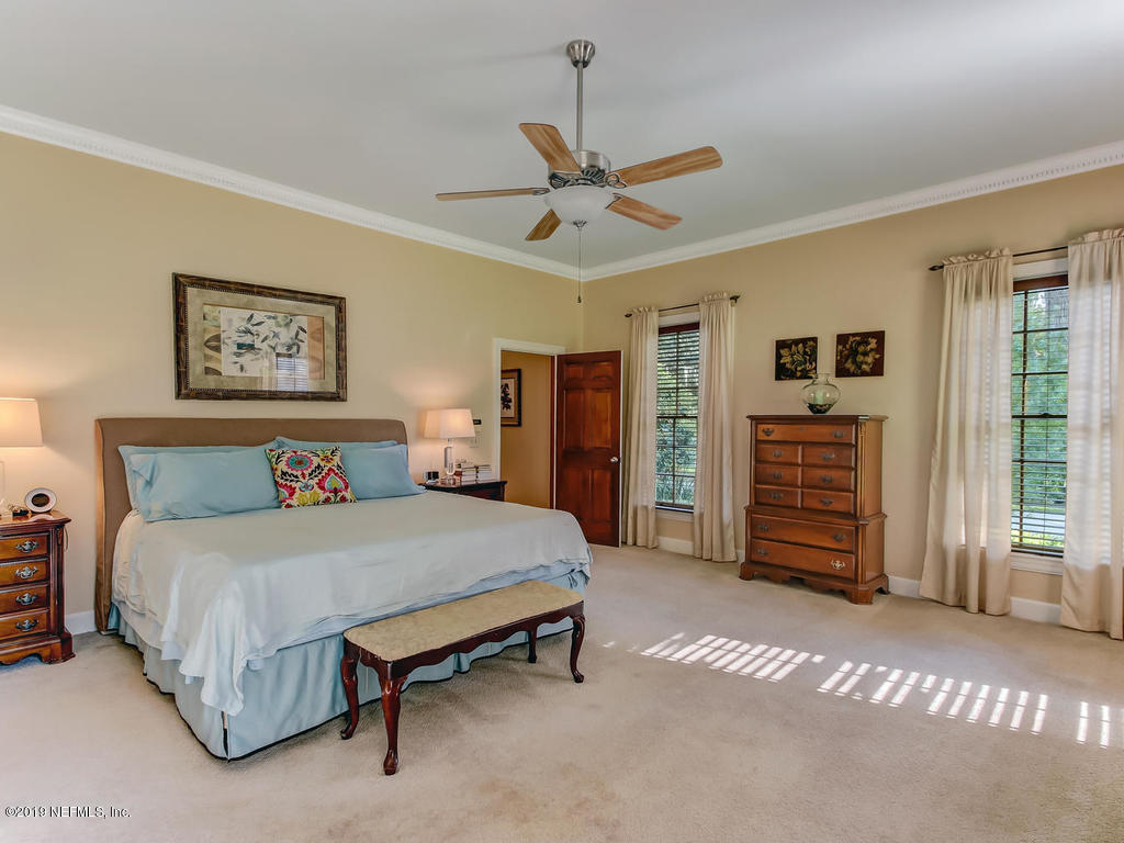 12200 Mandarin Road Jacksonville, FL 32223 - Photo 8 of 60 a bedroom with a bed and a chandelier