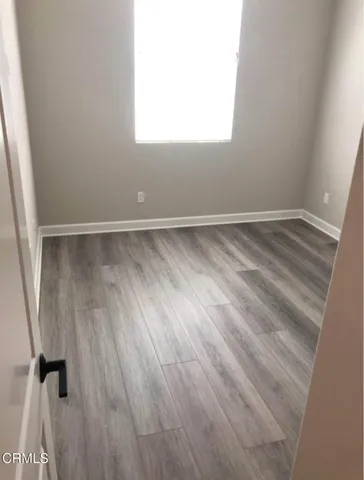 a view of a room with wooden floor and windows