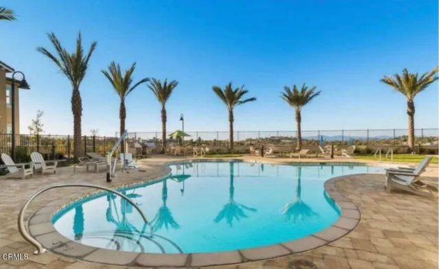 a view of a swimming pool with a lounge chair