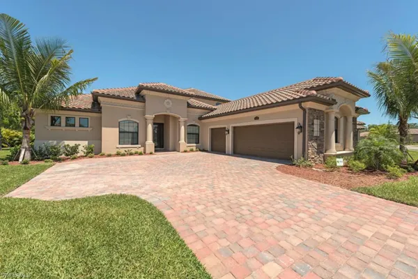 a front view of a house with a yard and garage