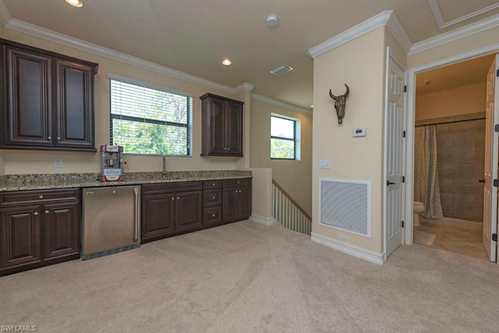 9560 Firenze Circle Naples, FL 34113 - Photo 12 of 19 a kitchen with granite countertop a stove a sink and a refrigerator