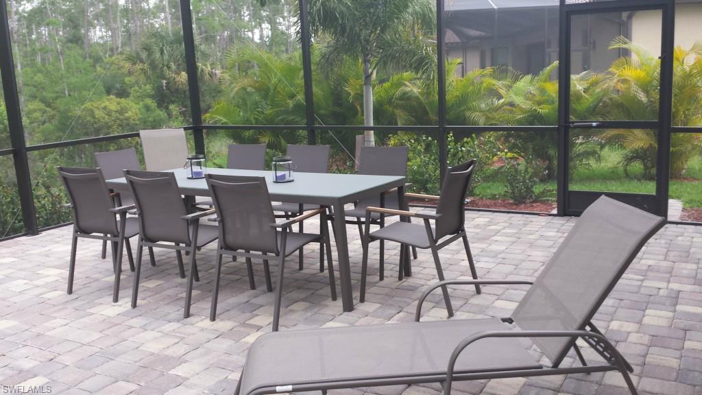 9560 Firenze Circle Naples, FL 34113 - Photo 16 of 19 a view of a balcony with a table and chairs