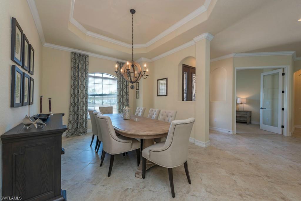 9560 Firenze Circle Naples, FL 34113 - Photo 2 of 19 a dining room with furniture a chandelier and wooden floor