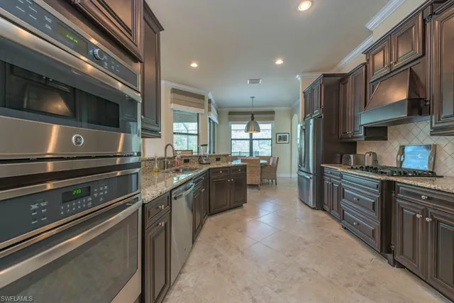 a kitchen with stainless steel appliances granite countertop a stove and a sink