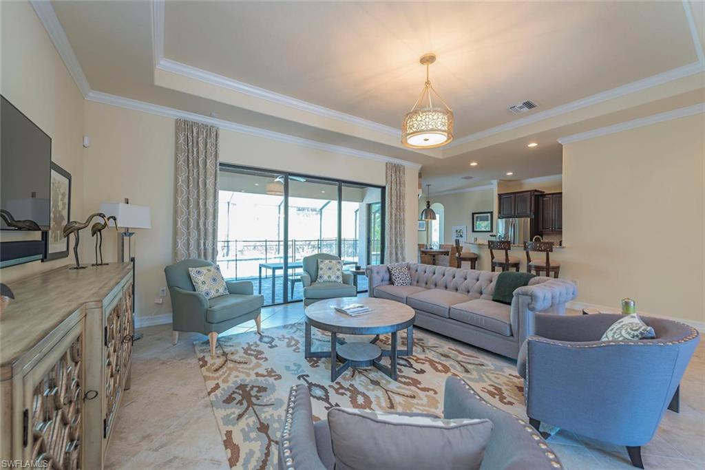 9560 Firenze Circle Naples, FL 34113 - Photo 6 of 19 a living room with fireplace furniture and a large window