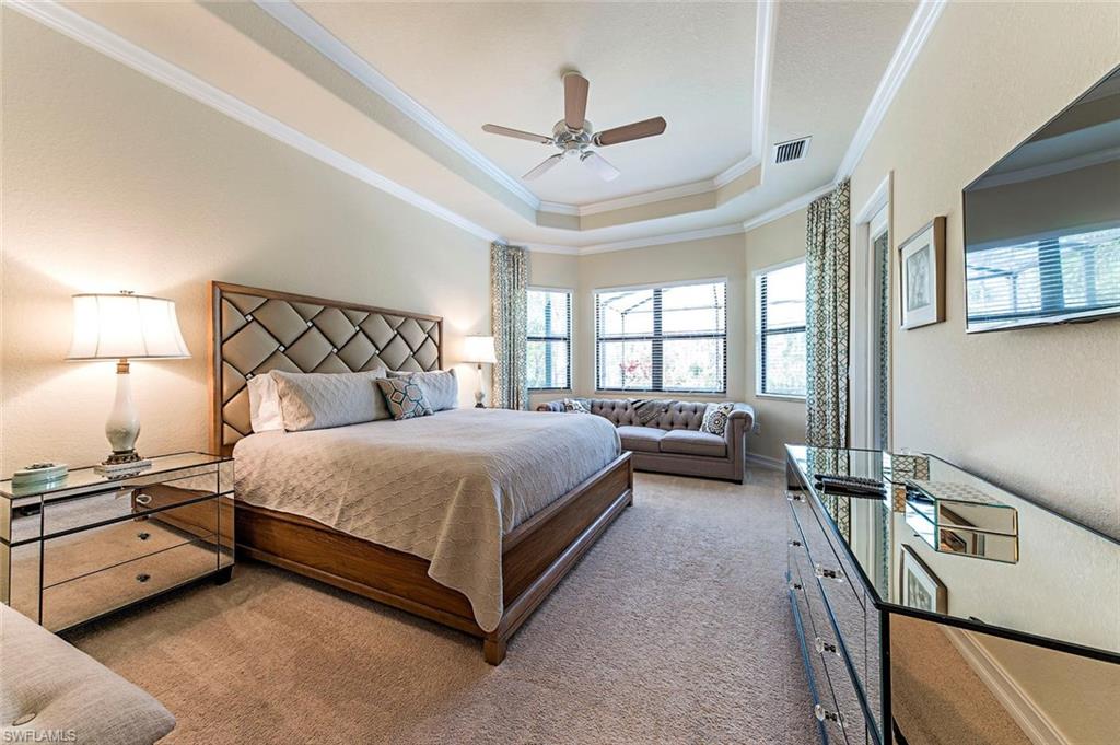 9560 Firenze Circle Naples, FL 34113 - Photo 7 of 19 a bedroom with a bed and a night stand