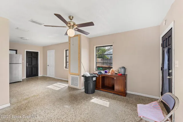 a view of a livingroom with furniture and windows