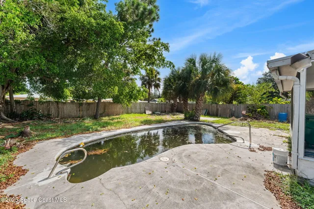 a swimming pool with outdoor seating and yard
