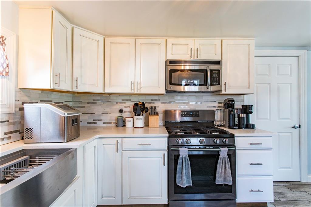 429 Big Knob Road Rochester, PA 15074 - Photo 4 of 27 a kitchen with stainless steel appliances granite countertop a stove a sink and a microwave