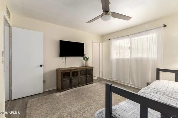 a view of room with flat screen tv and windows