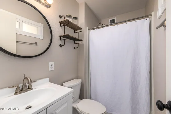 a bathroom with a sink toilet and mirror