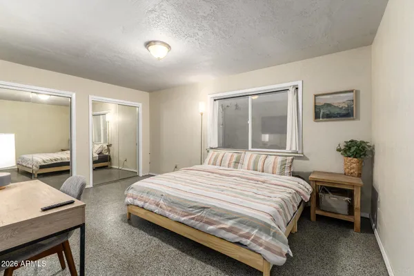 a bedroom with a bed and a table