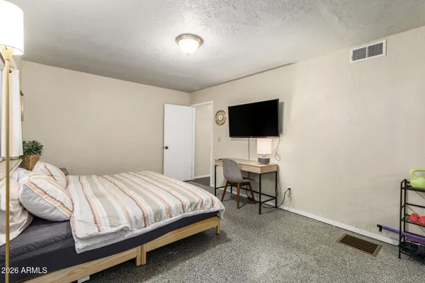a bedroom with a bed and a flat screen tv