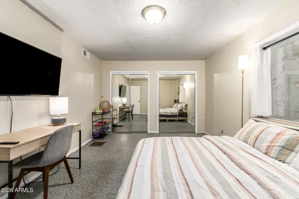 a bedroom with furniture and a flat screen tv