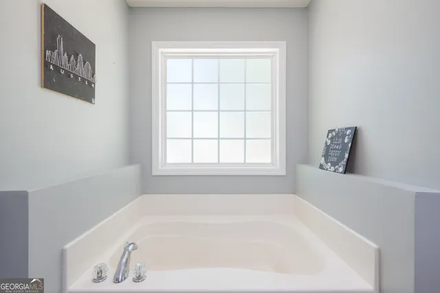 a white bath tub sitting next to a window